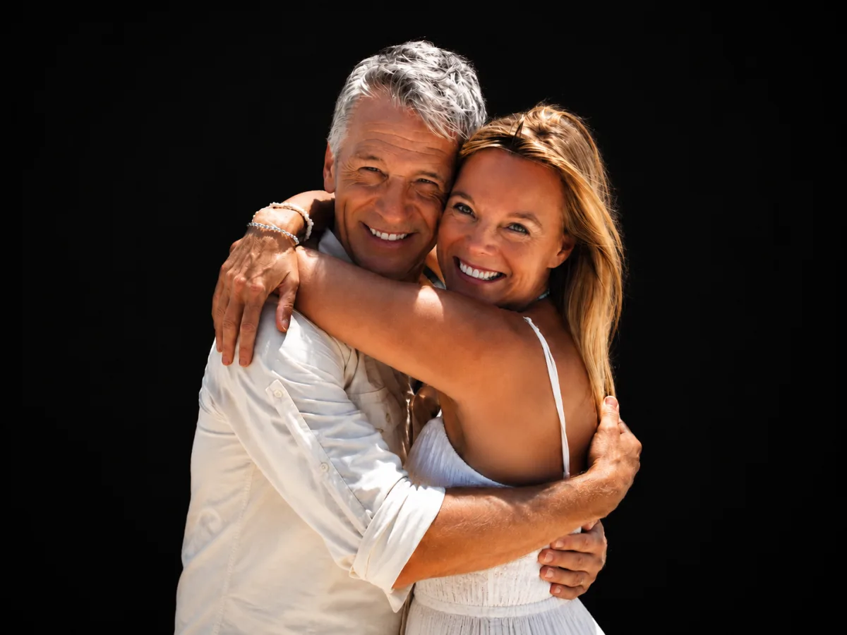 A couple with natural, confident smiles